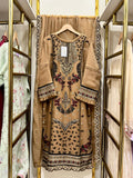Beige embroidered dress on a hanger in a store setting