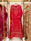 Red embroidered  gown dress on a hanger with gold racks and other dresses in the background